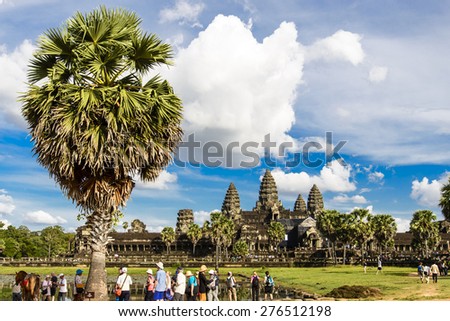 SIEM REAP, CAMBODIA - DECEMBER 5: Crowd of people at Angkor Wat on December 5, 2014. It is a temple complex in Cambodia and the largest religious monument in the world.