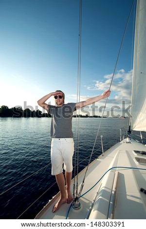 Happy young man on a yacht