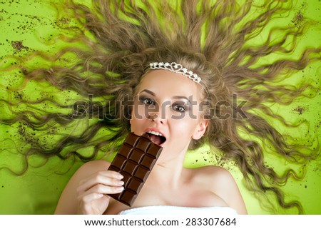 Young attractive woman eating chocolate