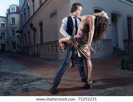Young couple perform dance steps on the street
