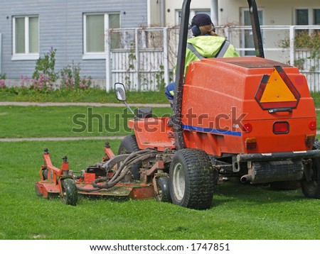 Grass cutting tractor in a back yard