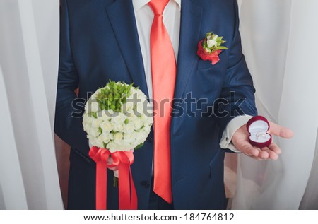 Engagement ring or present in the hands of a man in suit