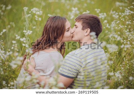 a young couple in love walking in the woods