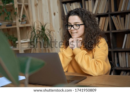 Hispanic teen girl, latin young woman school student, remote worker learning watching online webinar webcast class looking at laptop elearning distance course or video calling remote teacher.