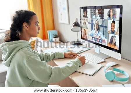 Mixed race teen school girl college student distance learning during virtual remote class, group online lesson on video conference call with teacher on computer screen studying at home by videocall.