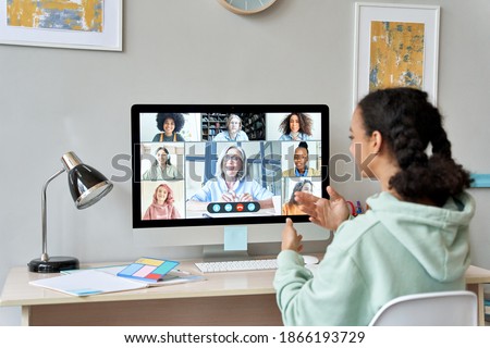 African teen high school girl college student distance learning virtual remote class, group online interactive lesson on video conference call talking with teacher on computer screen studying at home. Photo stock © 