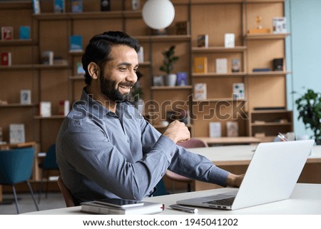 Happy indian professional young adult man having video conference call virtual business meeting working on laptop computer, enjoying watching online webinar, seminar training or remote class concept.