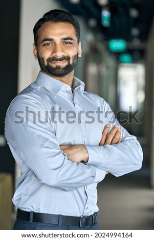 Smiling happy successful ceo financial manager confident bearded indian businessman looking at camera standing with arms crossed. Handsome classy corporation owner. Vertical business portrait. ストックフォト © 