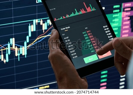 Crypto trader investor broker holding finger on buy or sell button executing financial stock trade market trading order thinking of cryptocurrency or shares assets investment risks and profit concept. Stockfoto © 
