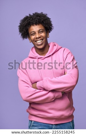 Similar – Image, Stock Photo Young afro American black man listening music with wireless headphones while wearing a white sweatshirt and a backpack looking to camera on a green and yellow wall background