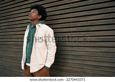 Similar – Image, Stock Photo Teenagers stand with closed eyes in front of a bright wooden wall and enjoy the wind in their hair.