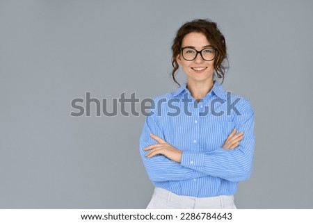 Similar – Image, Stock Photo Studio shot of pretty slim woman keeps hand in pocket, wears casual t shirt and jeans, stands in relaxed pose, looks at camera self confident, isolated over beige background talks casually with client