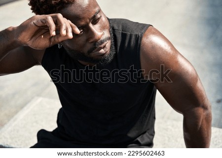 Image, Stock Photo Strong ethnic sportsman breathing during training on sports ground