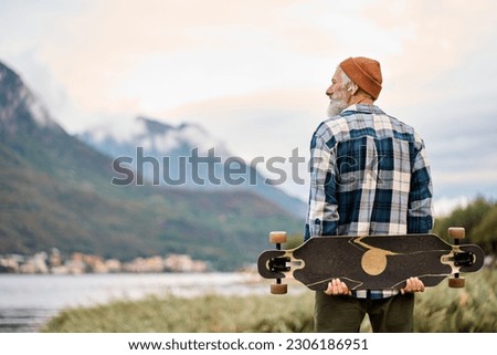 Similar – Foto Bild Entspannter männlicher Skater beim Musikhören in der Stadt