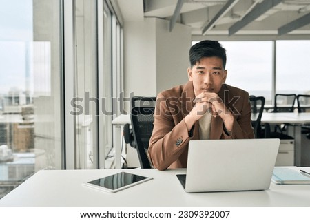 Similar – Image, Stock Photo Serious Asian man in face mask standing in gray corridor