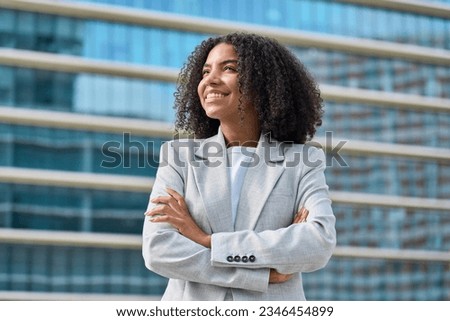 Similar – Image, Stock Photo Young african woman looking serious to camera during a exercise session in the city, urban style image, sport and activities in the city, copy space