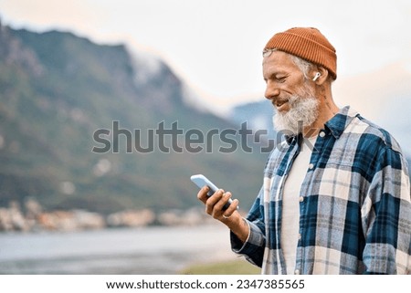 Similar – Image, Stock Photo Man with earbuds using tablet and laptop at table