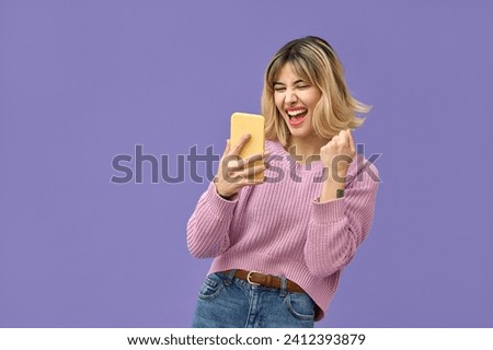 Similar – Image, Stock Photo Hands of a young person hold purple colored smartphone. The arms are placed on a wooden table top.