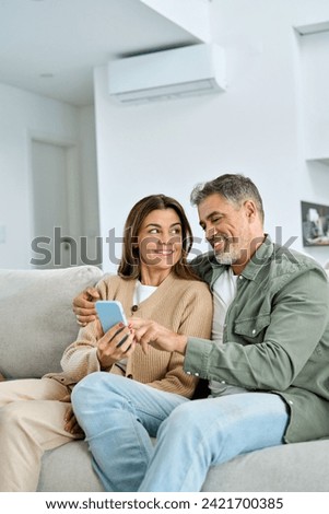 Similar – Image, Stock Photo Couple using smartphone together on bench