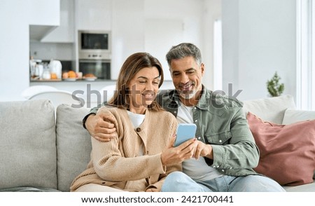 Similar – Image, Stock Photo Happy middle-aged couple sitting in bed in the morning drinking coffee and doing online shopping with a digital tablet