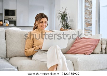 Similar – Image, Stock Photo Relaxed woman using laptop while resting on deck chair