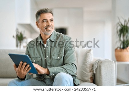 Similar – Image, Stock Photo Mature man reading book at home