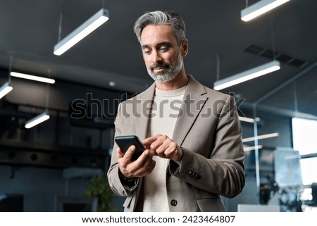 Similar – Image, Stock Photo Senior man using mobile phone on table near laptop