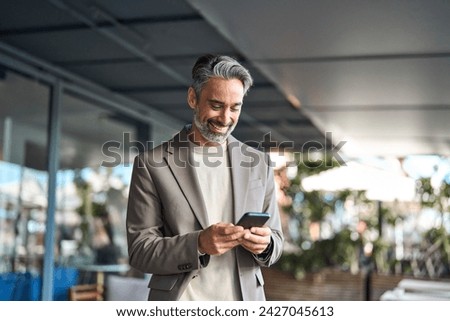 Similar – Image, Stock Photo Senior man using mobile phone on table near laptop