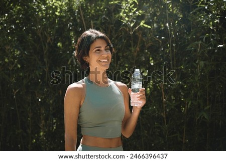 Similar – Image, Stock Photo Slim sportswoman drinking water in park