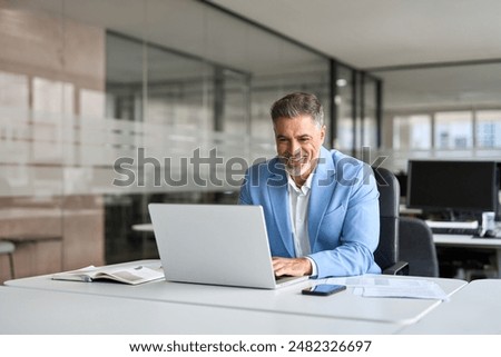 Similar – Image, Stock Photo Senior businessman in blue jacket using smartphone