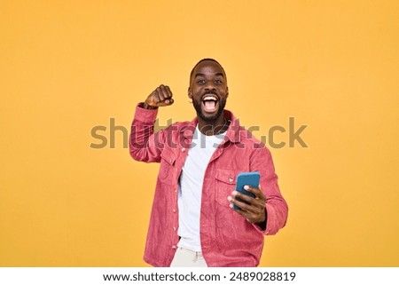 Similar – Image, Stock Photo Young black man holding wireless headphones while wearing a white sweatshirt, against a blue wall looking away with confidence. Selective focus