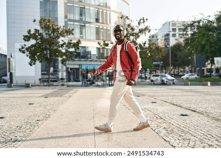 Similar – Image, Stock Photo A man with headphones pulls on his tongue with pliers