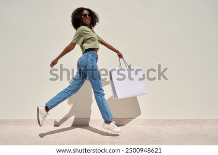 Similar – Image, Stock Photo Confident African American woman in stylish outfit at entrance of contemporary building with orange tiled facade