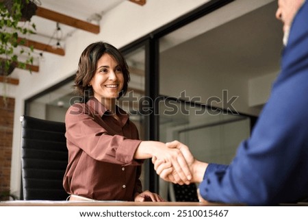 Similar – Image, Stock Photo Hands of a young person hold purple colored smartphone. The arms are placed on a wooden table top.