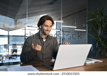 Similar – Image, Stock Photo Man with earbuds using tablet and laptop at table