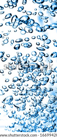 Vertical Strip of Blue Air Bubbles in Water. Clear background.