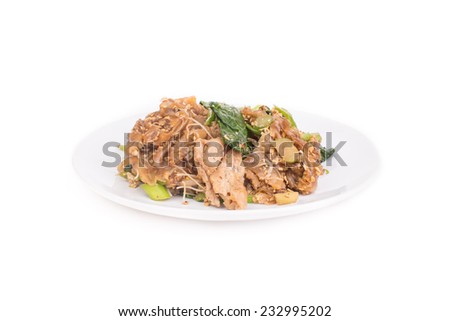 Soy sauce stir-fried noodles served on white dish on white background