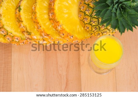 pineapple juice and Fresh slice pineapple on wood table
