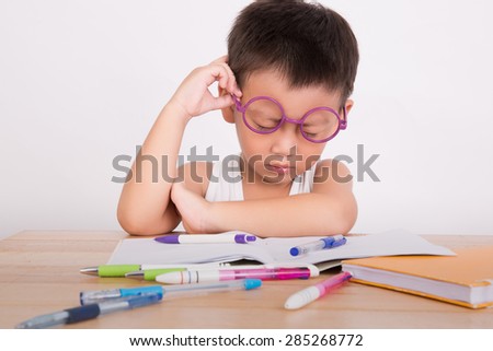 asian boy student to do homework at a table on a white background