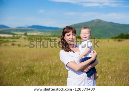 Family - happy mom and her son smiling at nature