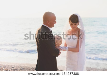 Happy newly married couple on their wedding day on the beach