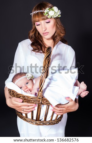 mother holds infant daughter in her arms