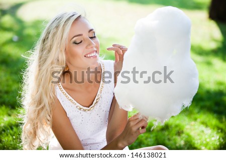 beautiful woman with candy floss in the park