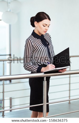 Portrait of business woman with paper folder