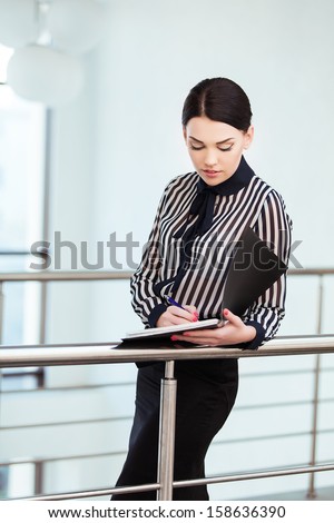 Portrait of business woman with paper folder