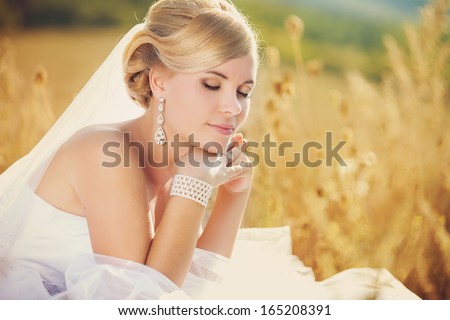 Beautiful bride outdoors, summer day