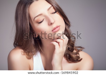 Portrait of a sensual woman. Natural beauty of a young woman in the studio. Head and shoulders portrait of a beautiful young woman