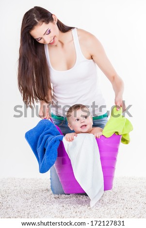 Mother with Son Sitting In Laundry Basket on white. Family, adorable kid, love and happiness concept.