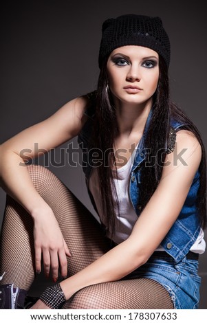young girl with unique fashion sense looking away