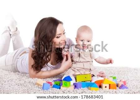 mother and baby playing with building blocks toy over white